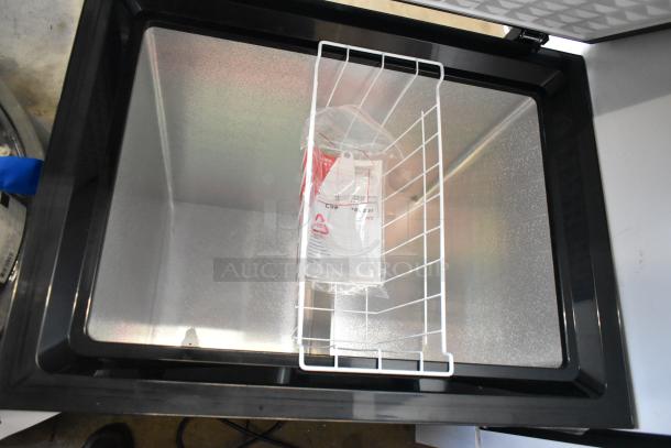 Frigidaire FGFRF5009-B-BLACK-6COM chest freezer, hinge lid open, brand new with tag, 115V 1 phase. Scratch and dent condition.