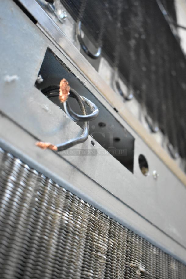 Scotsman C1030MA-32B stainless steel commercial ice head, 208/230 volts, 1 phase, highlighting electric wiring and metal casing.