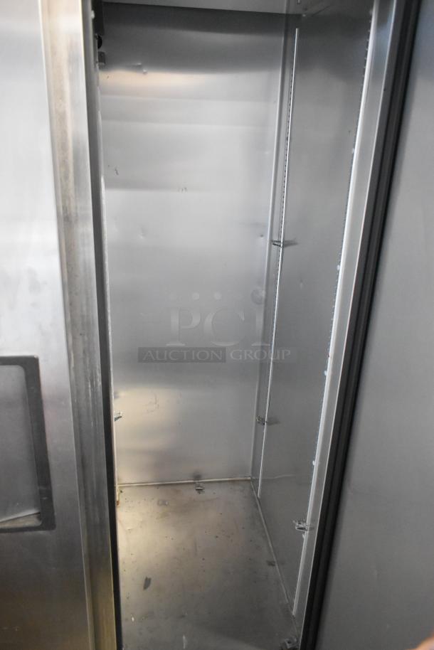 2021 True T-35-HC stainless steel 2 door reach-in cooler interior, showing spacious storage with poly-coated racks.