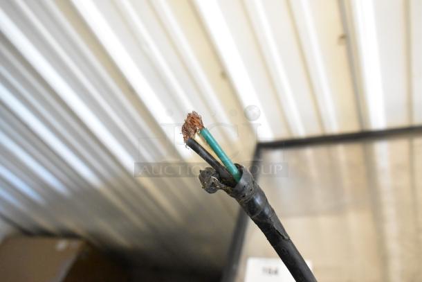 Damaged power cord with exposed wires, potentially from a True T-35-HC commercial cooler, indicating need for repair.