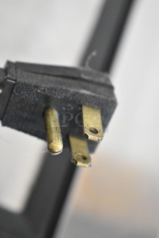 Close-up view of a three-prong plug for the 2017 True TD-65-24 back bar bottle cooler. This cooler operates on 115 volts, 1 phase.