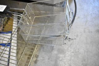Two metal fry baskets with wire mesh design, black handles, and a label indicating quantity x2. Ideal for commercial use.