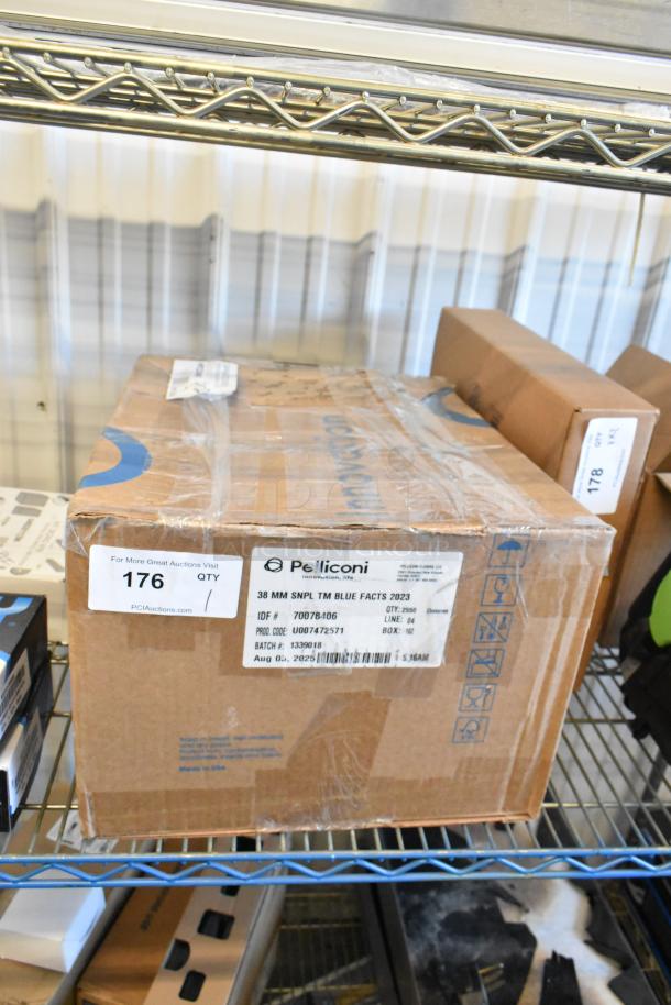 Cardboard box labeled "Pelliconi" with item and batch details, part of auction lot 176, on metal shelf. Contains broiler radiants.