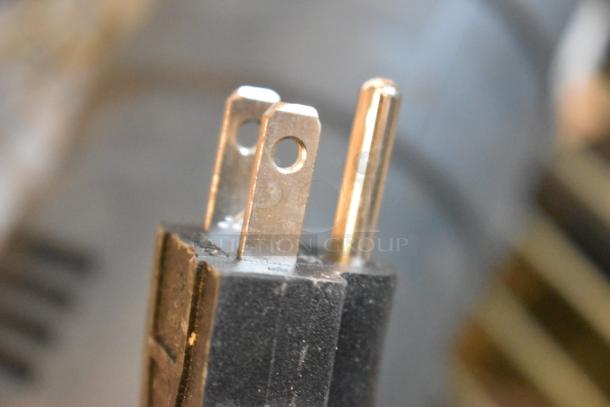 Close-up of a plug from the 2022 AvaMix 928IBMD10 immersion blender, showcasing its standard prong configuration.