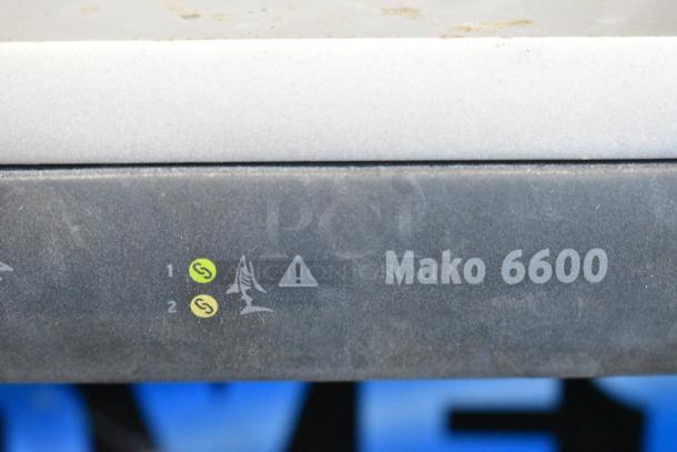 Mako 6600-M-W1-LTE Router, with visible indicators on front panel. Slightly dusty, good condition. Includes Sandwich Spreader.