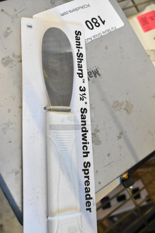 Sani-Sharp 3.5" Sandwich Spreader in original packaging, new condition, with white handle and stainless blade, NSF certified.
