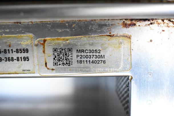 2018 Amana MRC30S2 microwave label showing model, serial number, and QR code on stainless steel surface. Signs of wear.