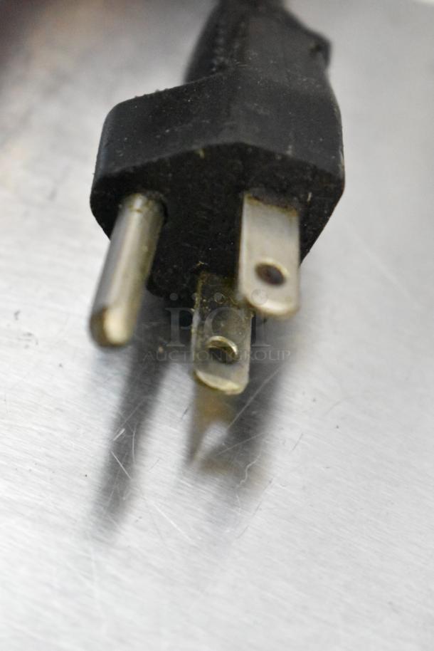 Power plug of Pitco Frialator stainless steel commercial fryer oil filtration system on a metallic surface.