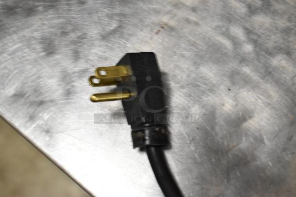 Close-up of a 115V electrical plug for a 2018 Hoshizaki CRMF48-WD4 stainless steel commercial cooler.