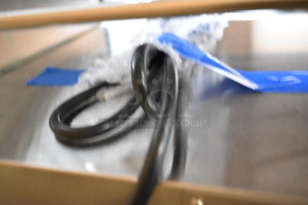 Blurred close-up image of a coiled power cord, part of the Avantco 177RG1850SLT hot dog roller grill packaging.