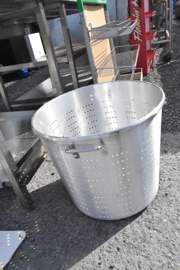 Town 38020 150 Qt. tapered aluminum vegetable colander with handles, features perforated sides, in good condition.