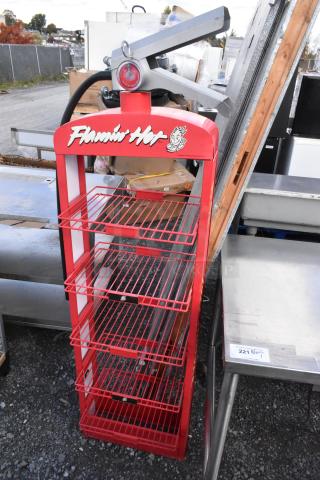 Red metal shelving unit with four tiers, featuring a decorative fire extinguisher top. "Flamin' Hot" logo on header. Good condition.