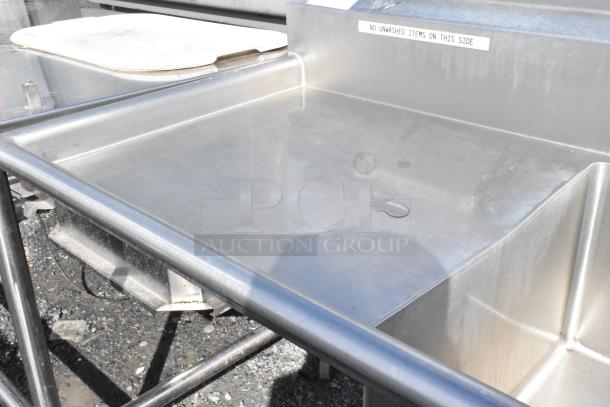Stainless steel 3 bay sink with dual drain boards, faucet, and handles, labeled for restricted use, in good condition.