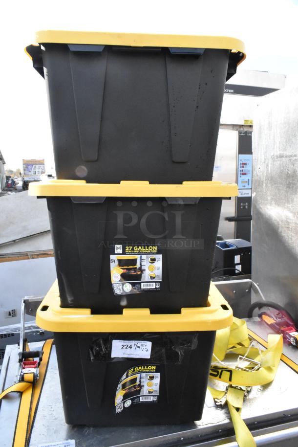 Three Member's Mark 27-gallon black poly totes with yellow lids, featuring durable construction and stackable design.