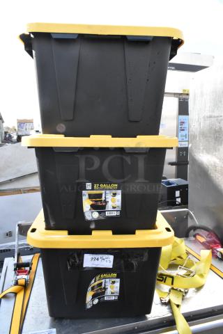Three Member's Mark 27-gallon black poly totes with yellow lids, featuring durable construction and stackable design.