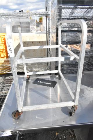 Metal pan transport rack with sturdy commercial casters. Used condition with scratch marks visible. Ideal for kitchen or bakery use.