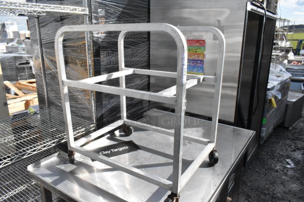 Metal pan transport rack with commercial casters, used condition, sturdy metal frame, ideal for kitchen storage and transport.