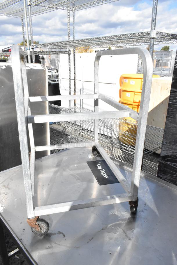 Metal pan transport rack with commercial casters, silver finish, used condition, ideal for kitchen or catering use.