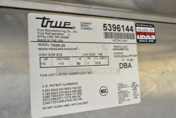 True TR2R-2S stainless steel commercial 2-door reach-in cooler, missing door, 115 volts, model label details.