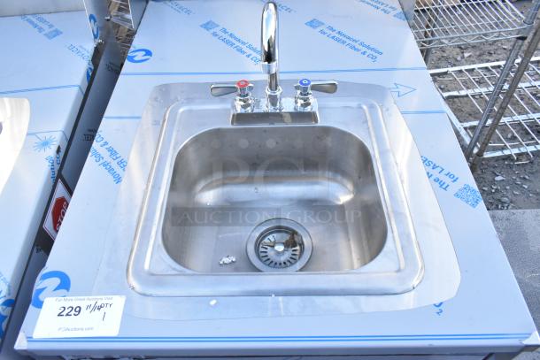 QualServ stainless steel portable sink on casters, brand new, scratch and dent condition. Features hot and cold faucets.