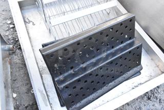 Lot of 5 metal pieces including perforated black pans, varying shapes, used condition, suitable for industrial use.