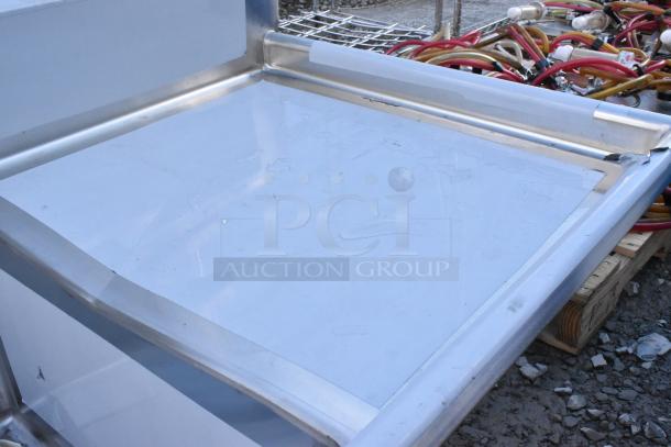 Regency 600S32424224 stainless steel 3 bay sink with dual drain boards, scratch and dent, no legs visible.