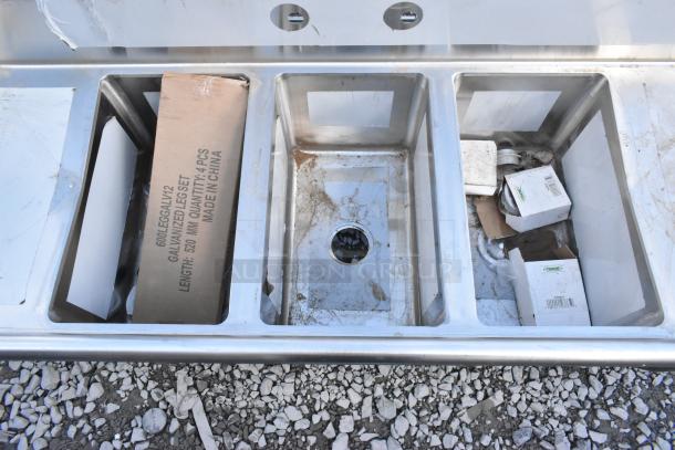 Brand new Regency 600S31220212 stainless steel 3-compartment commercial sink, 16-gauge, with 2 drainboards, minor dents.