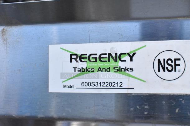 Alt text: Regency 600S31220212 stainless steel three-compartment sink with galvanized legs, NSF label visible, scratch and dent condition.