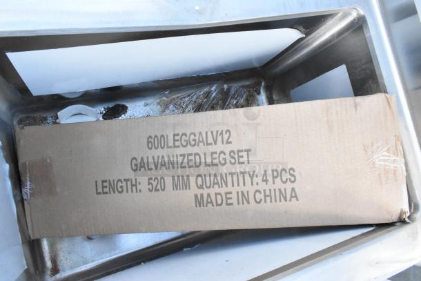 Regency 600S31220212 commercial sink with scratch and dent, three 12"x20"x12" bowls, galvanized legs, two drainboards.