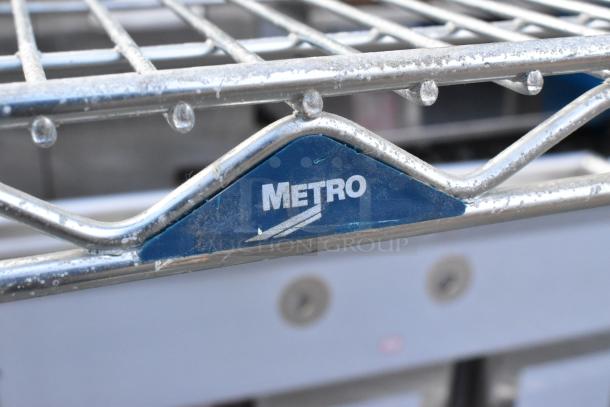 Chrome finish 4-tier Metro wire shelving unit, features label. Buyer must dismantle. Consider freight charges.