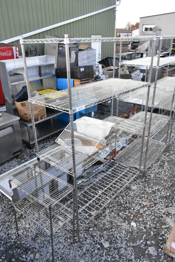 Chrome finish 4-tier wire shelving unit in used condition. Requires dismantling for buyer. Suitable for heavy storage.
