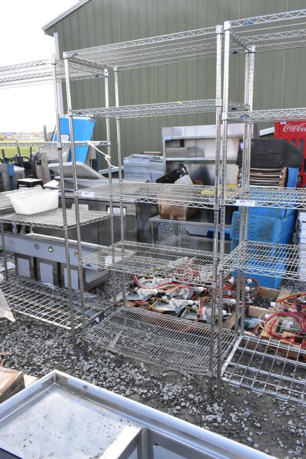 Metro 5-tier chrome wire shelving unit, in used condition, outdoors. Buyer must dismantle. Shipping charges apply.