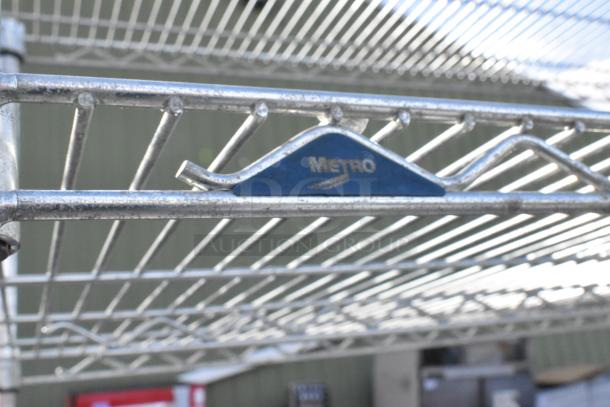 Metro 5 tier chrome wire shelving unit. Must be dismantled by buyer. Visible Metro label on chrome finish.