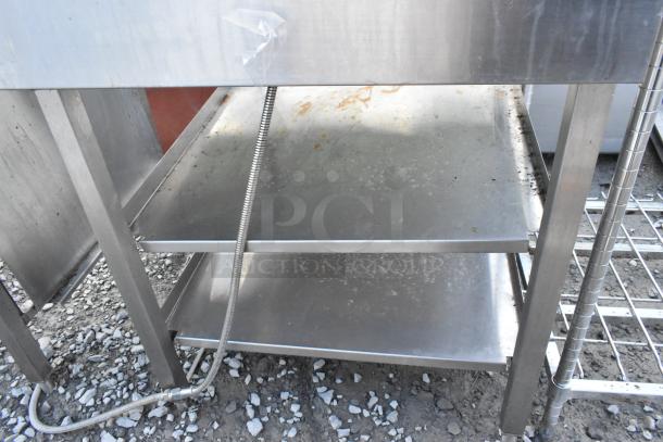 Stainless steel commercial soda station with under shelves. Sturdy construction, signs of use. Suitable for high-traffic areas.