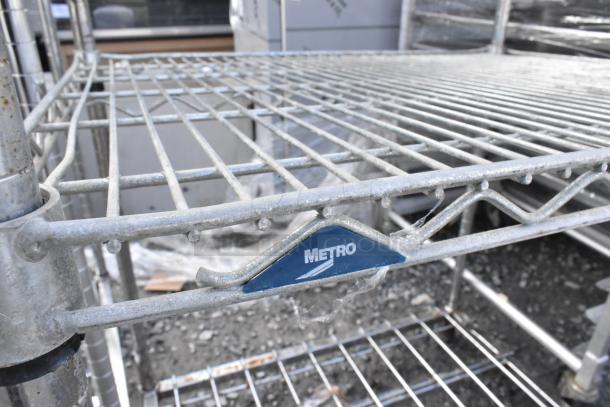 Metro Chrome Finish 5 Tier Wire Shelving Unit, sturdy metal construction, visible blue Metro label, buyer must dismantle.