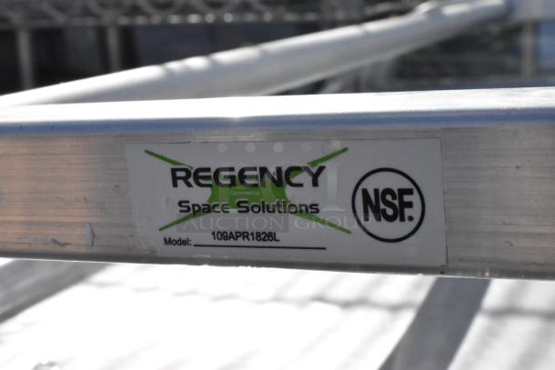 Two Regency Space Solutions metal pan racks with baking pans, Model 109APR1826L, NSF certified, used condition.