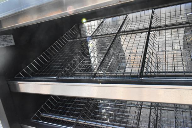 Vulcan 1013776 metal bakery donut display rack with metal baskets, commercial casters, visible brand tag.