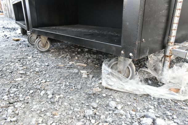 Vulcan 1013776 metal bakery display rack on casters with metal baskets. Features sturdy wheels, suitable for pastries and donuts.