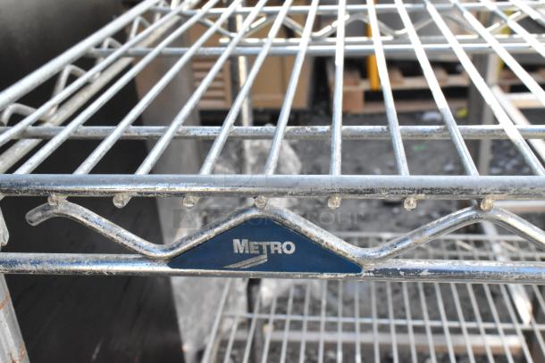 Metro 5-tier wire shelving unit, chrome finish, visible brand label. Condition: Used. Buyer must dismantle.