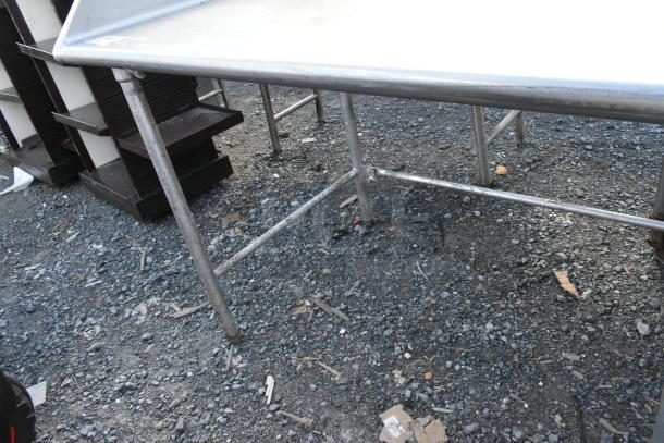 Stainless steel table with sturdy legs, appears in good condition. Ideal for industrial or kitchen use. No visible markings.