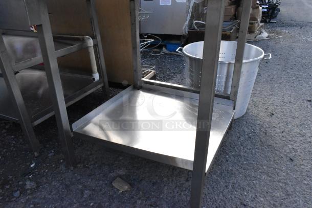 Stainless steel soda station with under shelves, featuring a sturdy frame and ample storage space. Good condition.