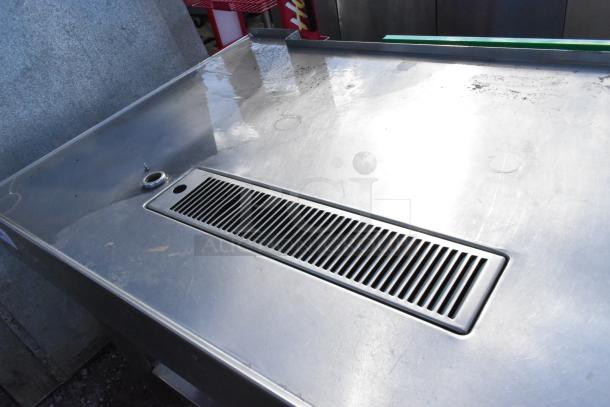 Stainless Steel Soda Station with vent detail; features under shelves; surface shows light wear.
