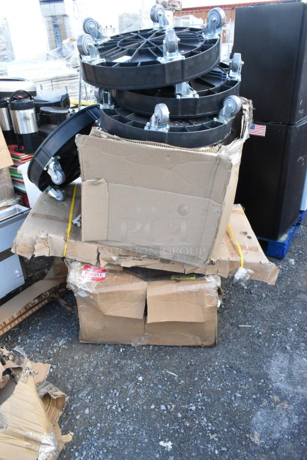 Stacked boxes containing Lavex 475DRDOLLY drum dollies, Regency work table, and utility sink. Boxes are damaged but items are brand new.