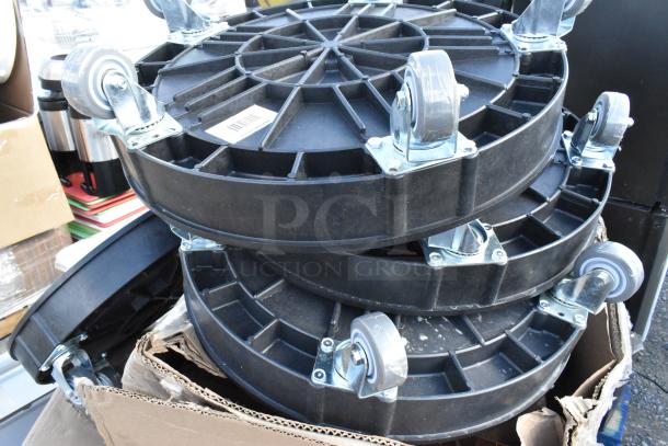 Three new Lavex 475DRDOLLY drum dollies in black, gray wheels; piled in cardboard box, scratch and dent condition.