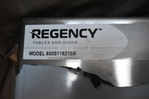 Regency utility sink label, Model 600S11821SB, slightly scratched, indicating brand and model for sink auction item.
