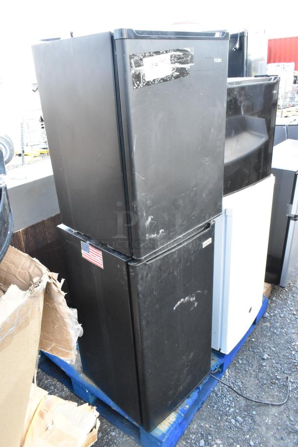 Four mini coolers including Haier HC27SF10RB, Nostalgia IRF32BK, Haier QHE02GGMBBB, GE GME04GGKBWW on pallet. 115V, 1 Phase. Visible scratches and worn labels.