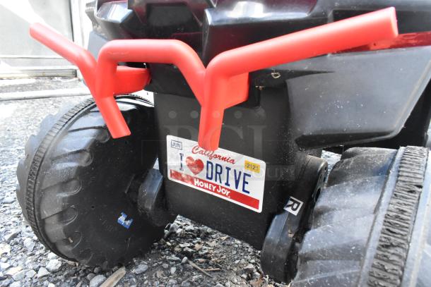 Hero No Fear Black and Red Children's ATV with large tires and mock license plate reading "I ❤ DRIVE Honey Joy."