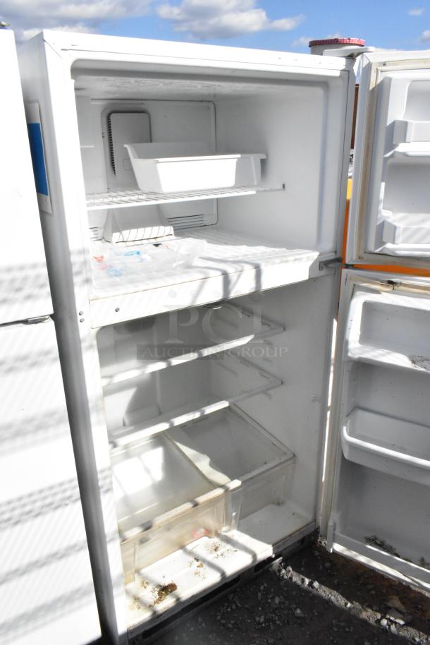 Maytag single door reach-in cooler with freezer, 115 volts, 1 phase, interior shelves, visible wear, suitable for storage.