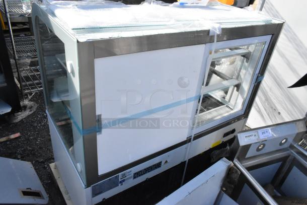 Brand new Avantco BC-48-HC curved glass display case with broken glass. Model 193BC48HCW, 115V, 1 Phase. White exterior.