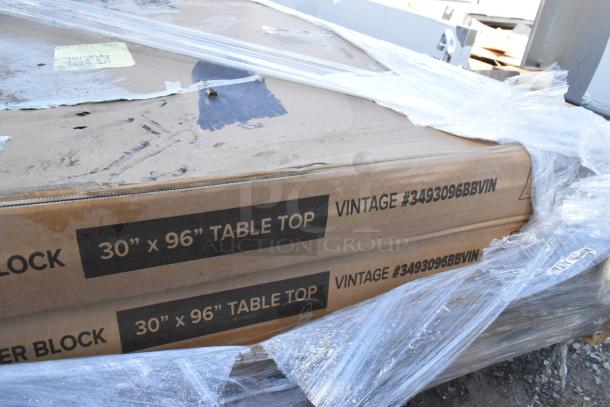 Cardboard boxes with Lancaster Table & Seating 30" x 96" butcher block table top, vintage finish, visible label #3493096BBVIN.
